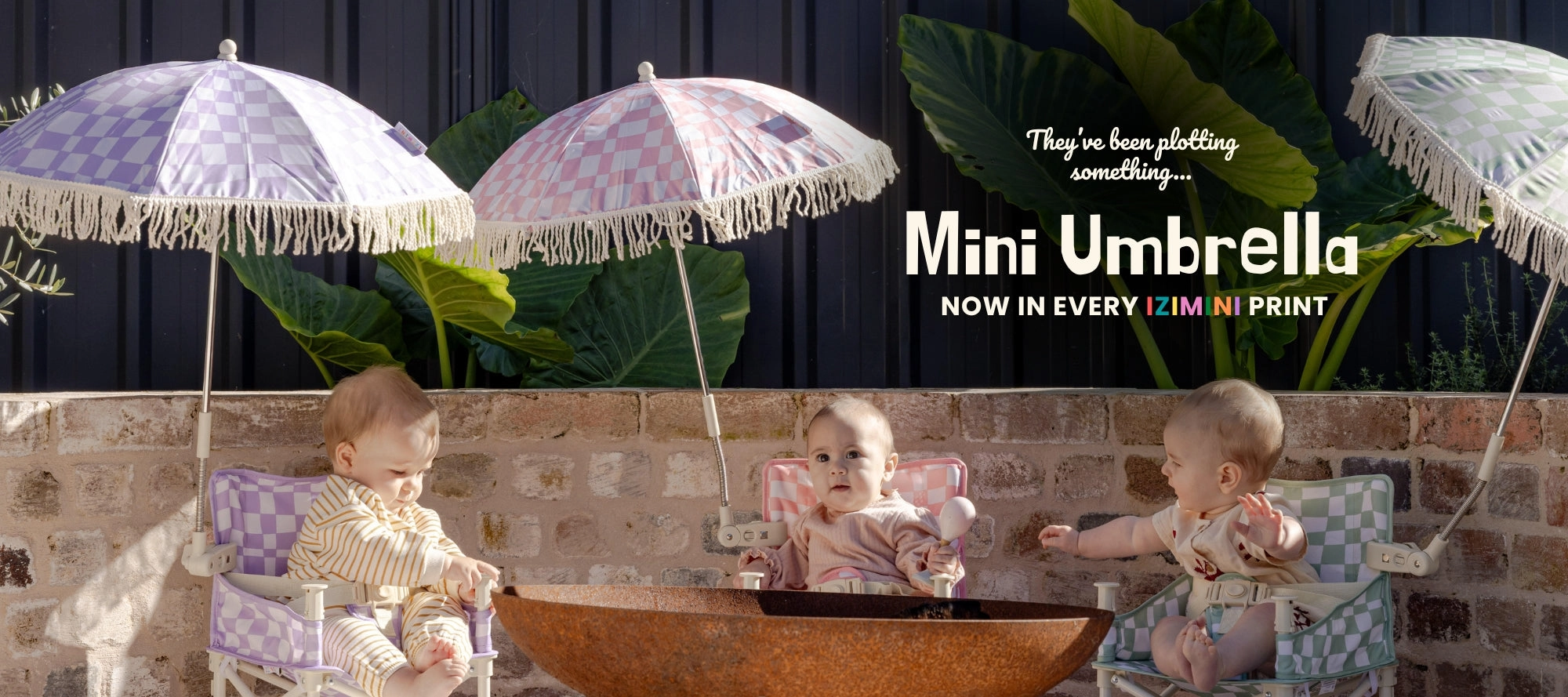 Three babies under fringed IZIMINI Mini Umbrellas