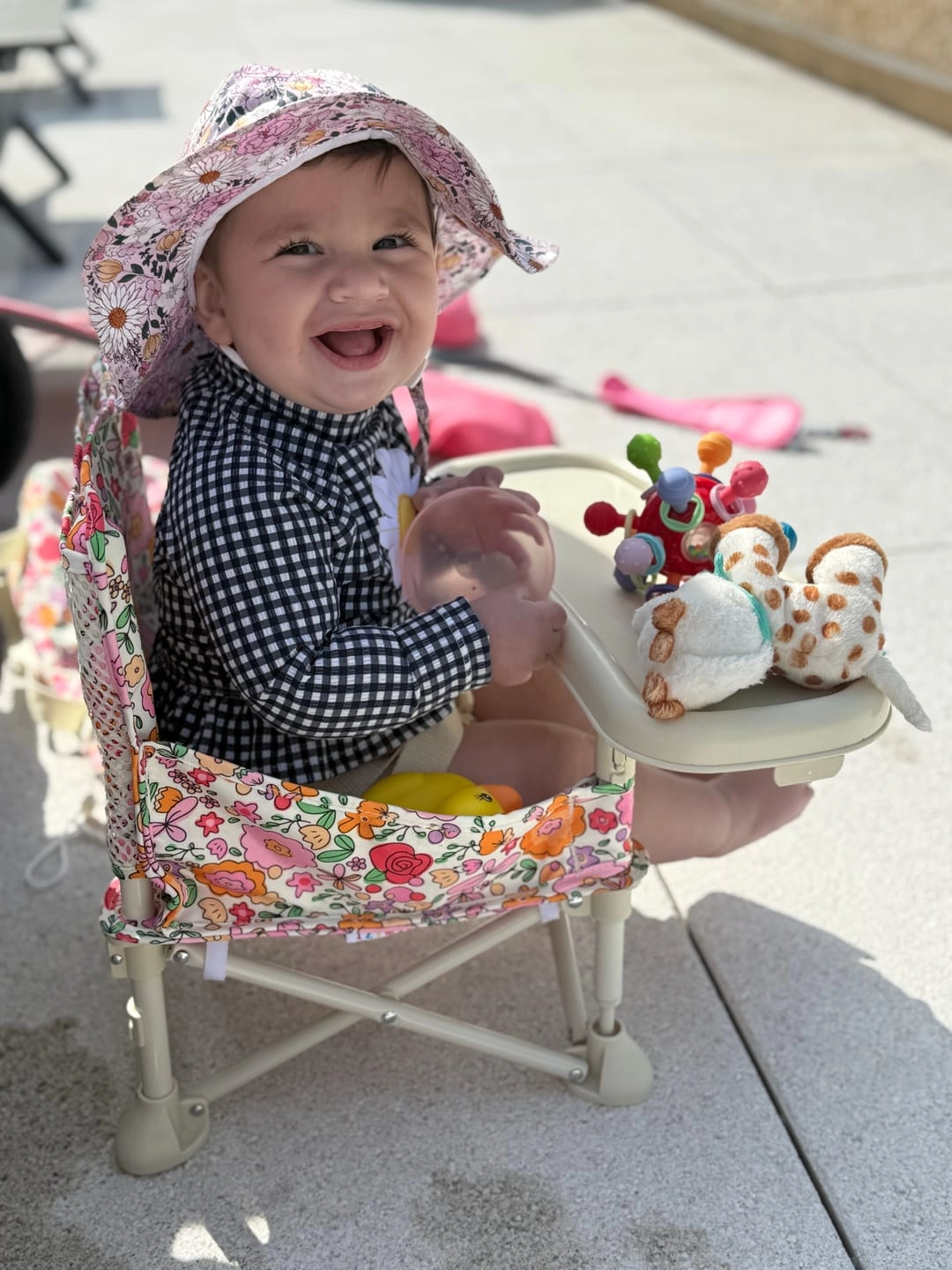 Customer photo review of a smiling baby in a Paloma portable booster chair V2